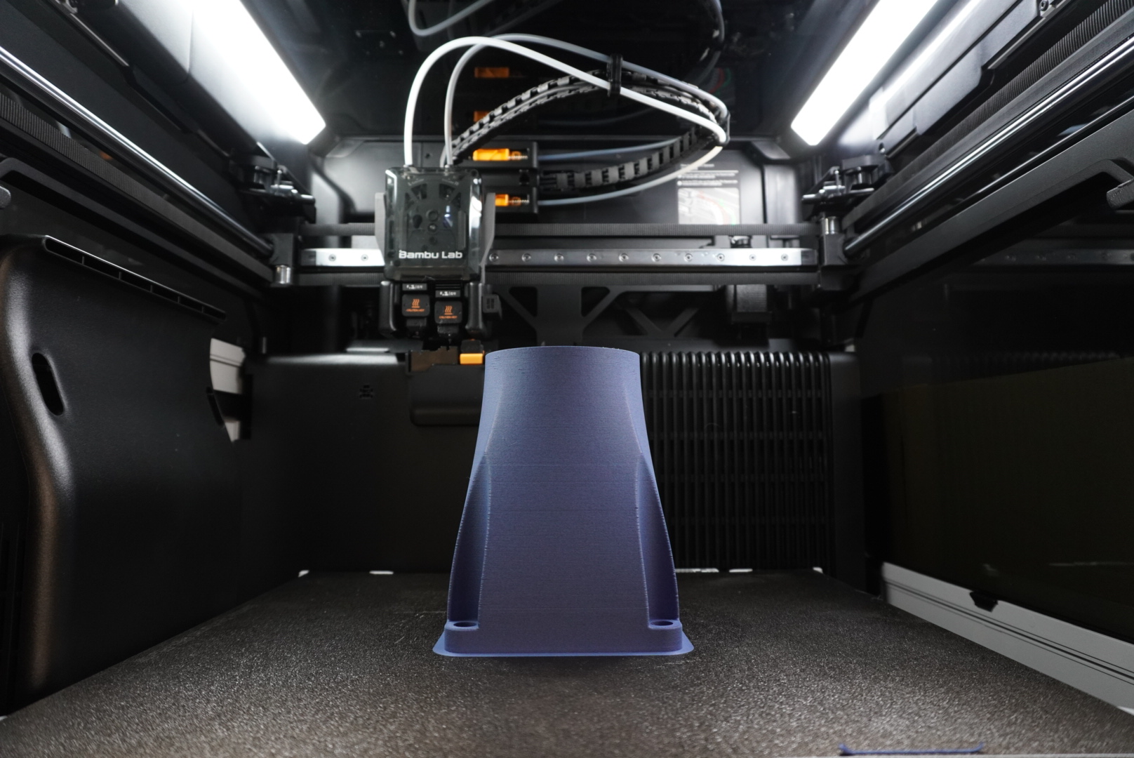 Schienke's in-house 3D printer producing a prototype component